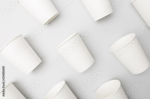 Blank white paper cups on the gray background