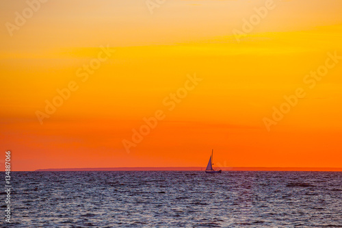 Beautiful orange sunset and boat on the Baltic sea