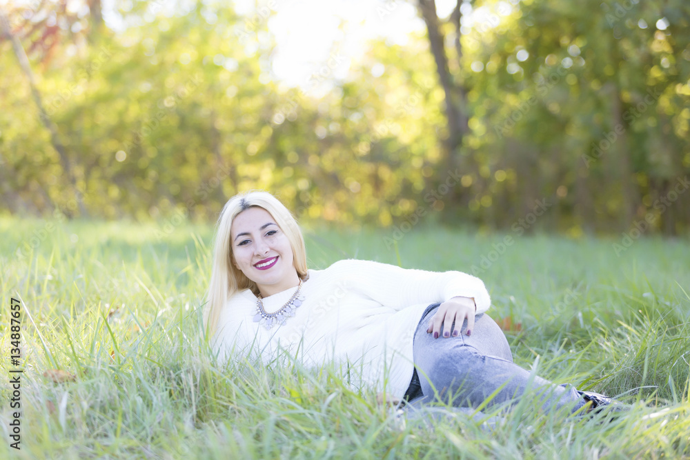 High School Senior portraits laying in grass on sunny day High School Senior portraits laying in grass on sunny day