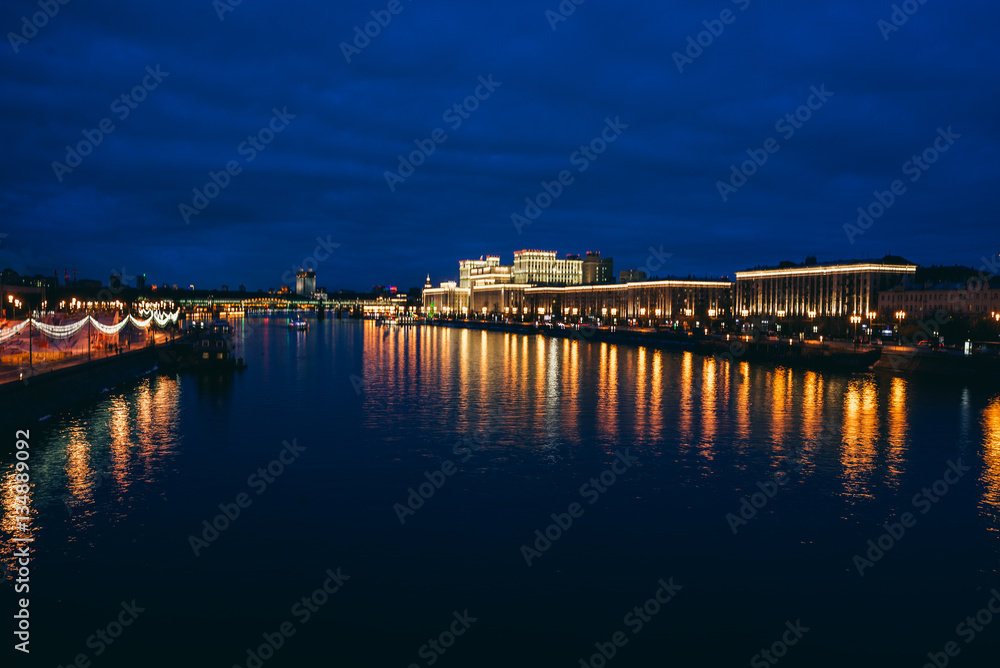 Moscow, Russia. Night cityscape with  bridge and Moscow river. Color bars on the headlights. Slow shutter speed