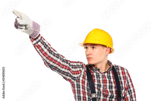 young worker with yellow and workers gloves pointing upward