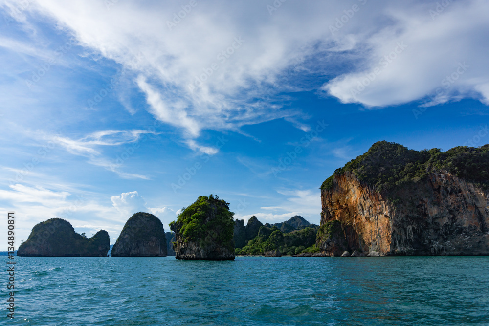 Island cliffs in turquois sea and blue sky Island cliffs in turquois sea and blue sky