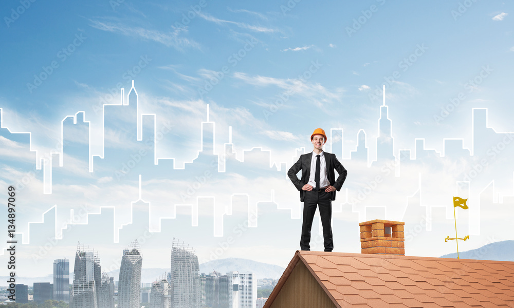 Engineer man standing on roof and looking away. Mixed media Engineer man standing on roof and looking away. Mixed media