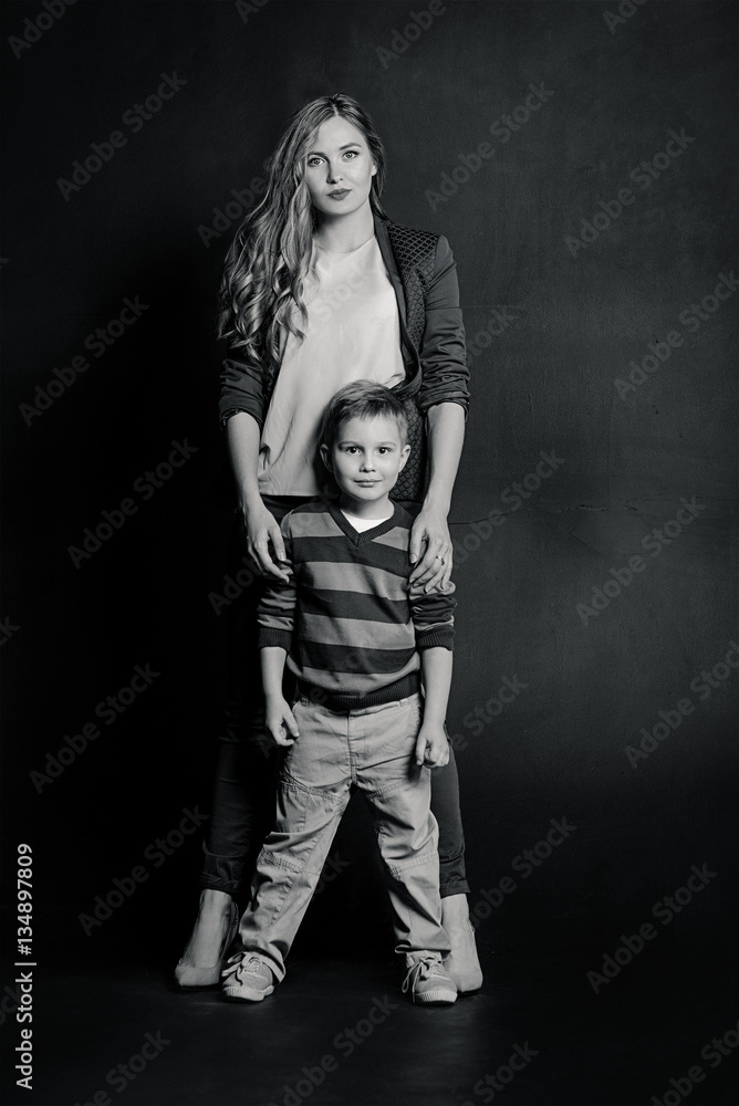 portrait of stylish cute little boy with beautiful mom in photo studio portrait of stylish cute little boy with beautiful mom in photo studio