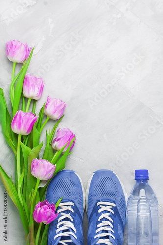 Spring flatlay sports composition with blue sneakers and purple