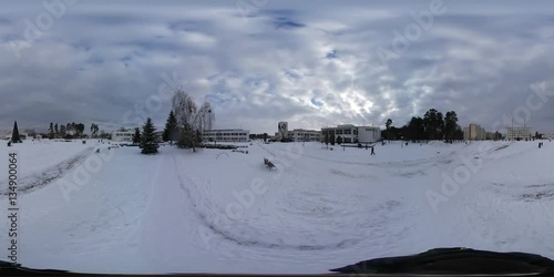 360 vr Video Camera Moves by Wintry Square Alleys View of the Center of Provintial Town Slavutich Snowy Day Evening Buildings on Background of Cloudcape photo