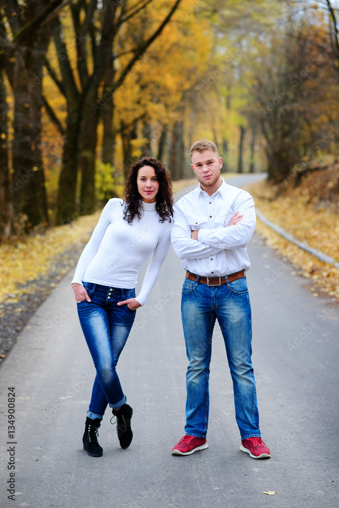 Lovers walking hand in hand in autumn park Lovers walking hand in hand in autumn park