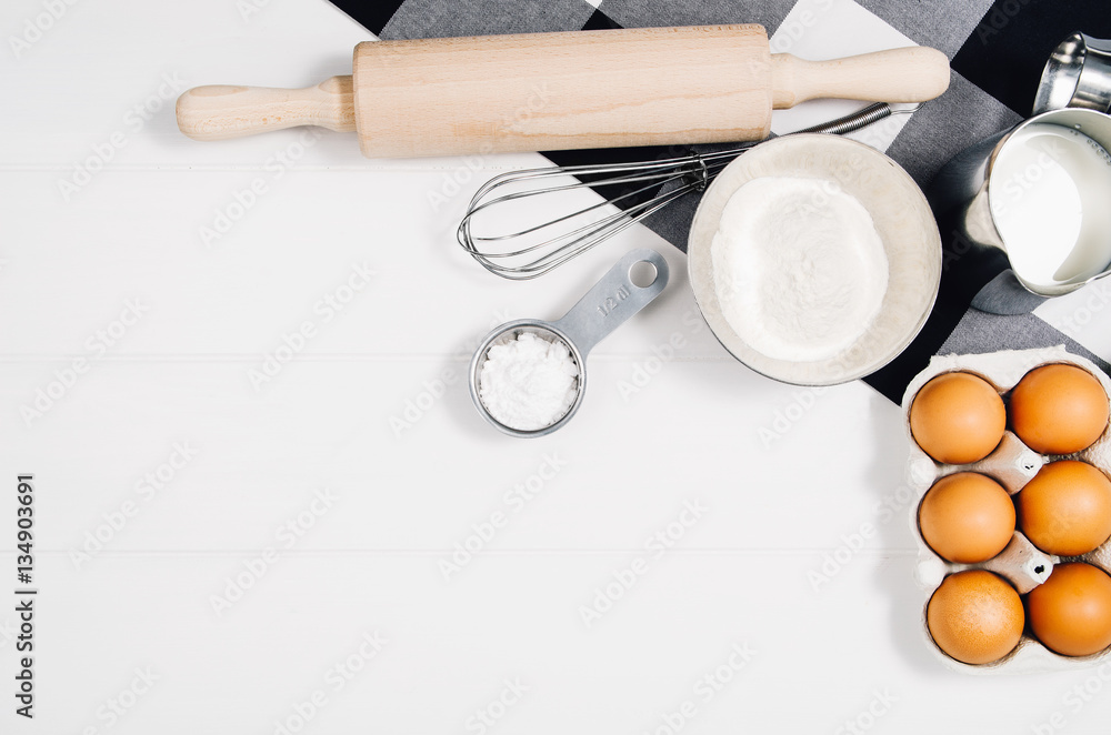Baking a cake or pizza ingredients background. Top view photograph with kitchen utensils on vintage, natural, white, wooden background. Baking a cake or pizza ingredients background. Top view photograph with kitchen utensils on vintage, natural, white, wooden background.