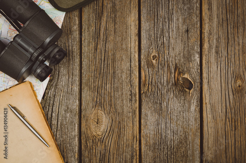 Accessories for travel top view on wooden background with copy space. Adventure and wanderlust concept image with travel accessories. Preparing for an exotic trip, journey and sightseeing.