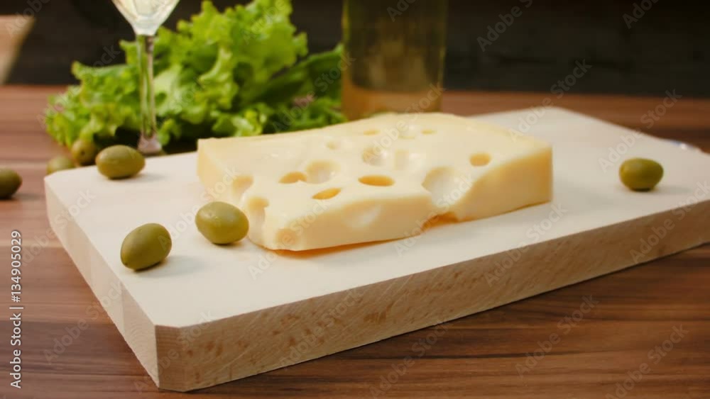 Circular movement of the camera around pieces of French cheese on a wooden table. Circular movement of the camera around pieces of French cheese on a wooden table.