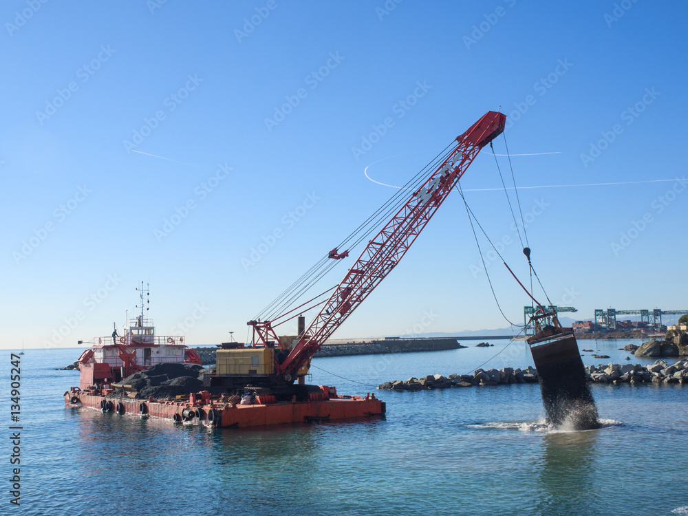 Grab Dredge with Clamshell Bucket unloading gravel to replenish