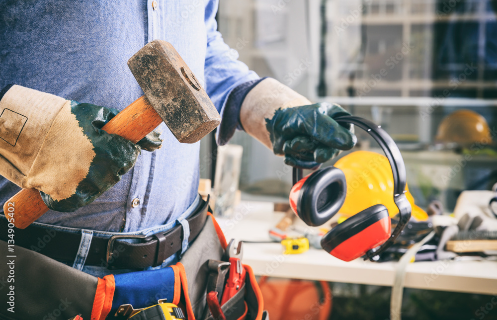 Fototapeta premium Worker with a tool belt and a hammer