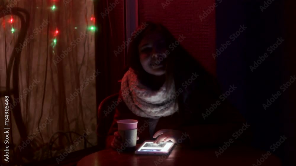 Plump Girl working on tablet drinking tea Plump Girl working on tablet drinking tea