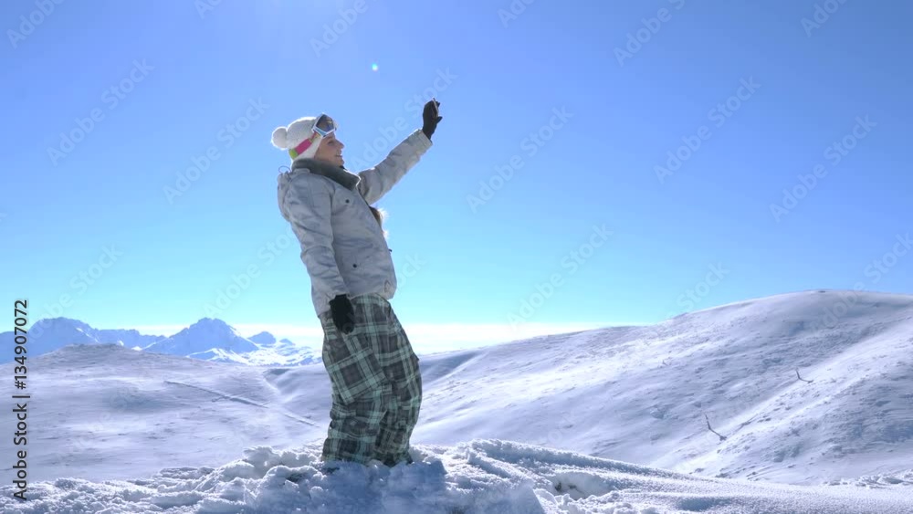 Woman snowboarder makes selfie at the top of the mountain Woman snowboarder makes selfie at the top of the mountain