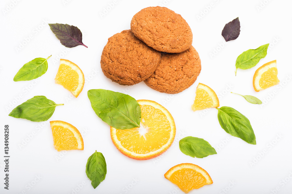 oatmeal cookies, mint leaves and orange dessert isolated on white