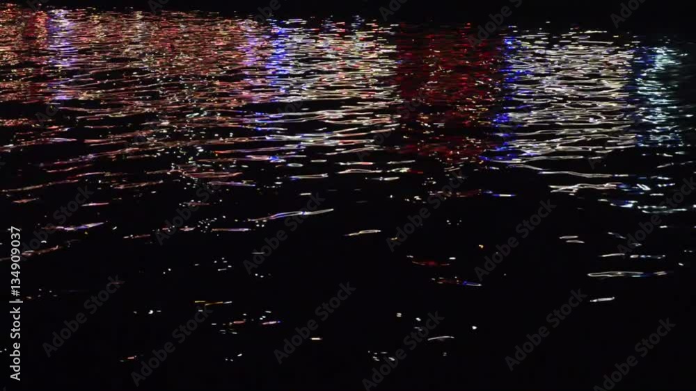 Beautiful lights of the night city life reflect in the dark water Stock ...