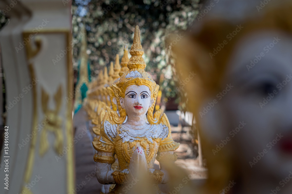 The plaster statue on the temple fence.