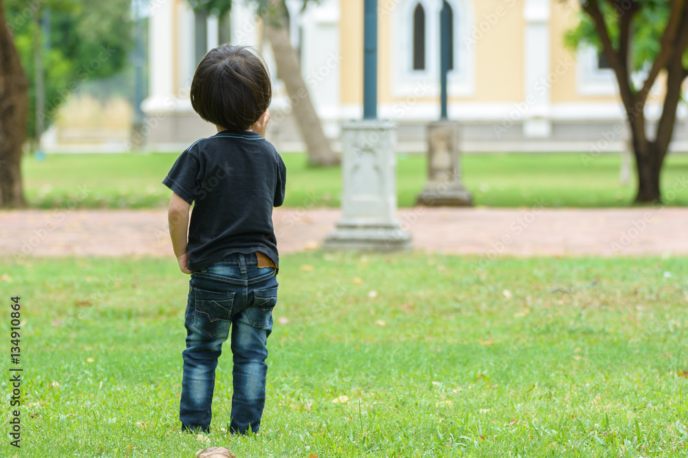 Beautiful baby girl is walking in the summer park Beautiful baby girl is walking in the summer park