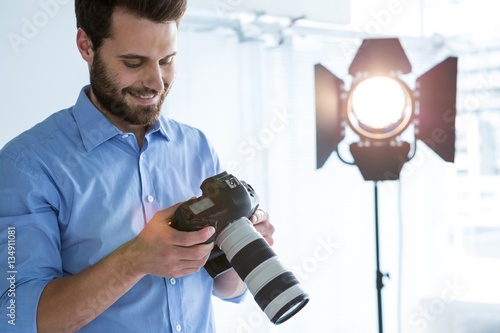 Photography Male photographer reviewing captured photos