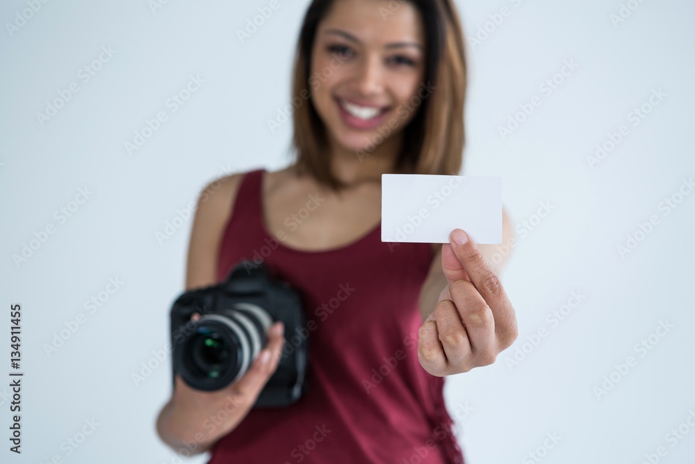 Female photographer showing visiting card in studio Female photographer showing visiting card in studio