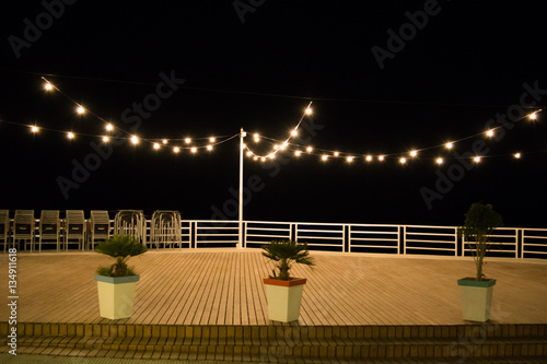 Night empty cafe or restaurant scene with the light bulbs