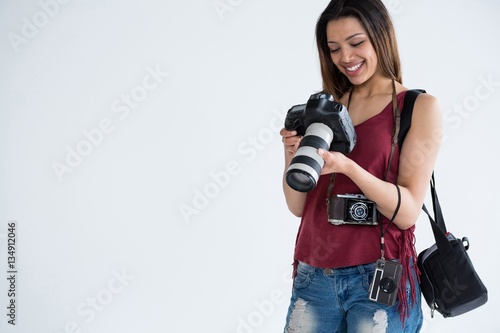 Canvas Print Female photographer reviewing captured photos