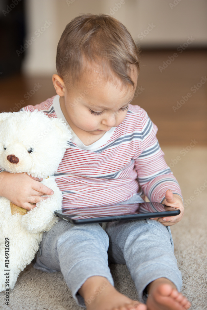 Little boy with teddy bear and tablet. Little boy with teddy bear and tablet.
