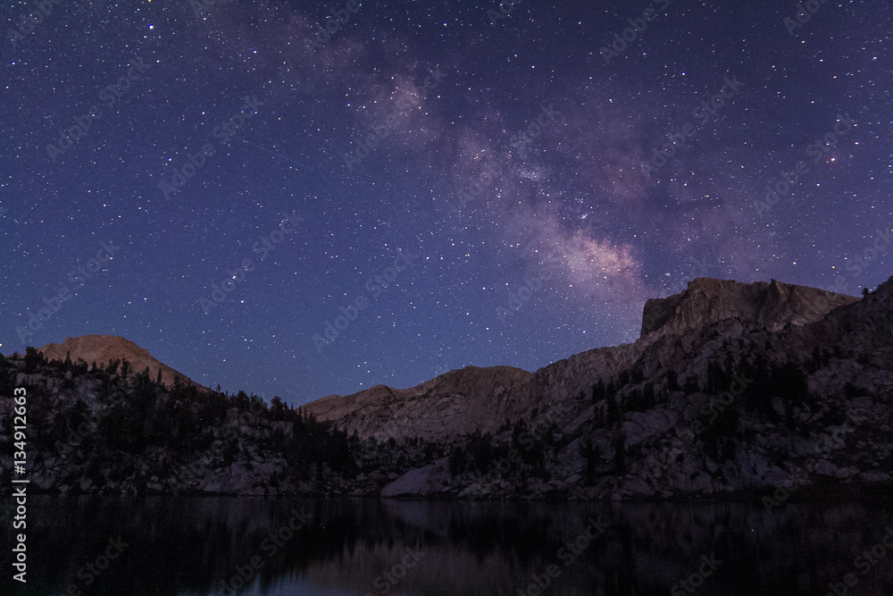 Milky way rises over a granite bluff at the Lake of the Lone Indian in the high sierra