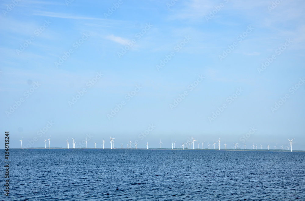 wind farm in the Baltic Sea with dozens of windmills