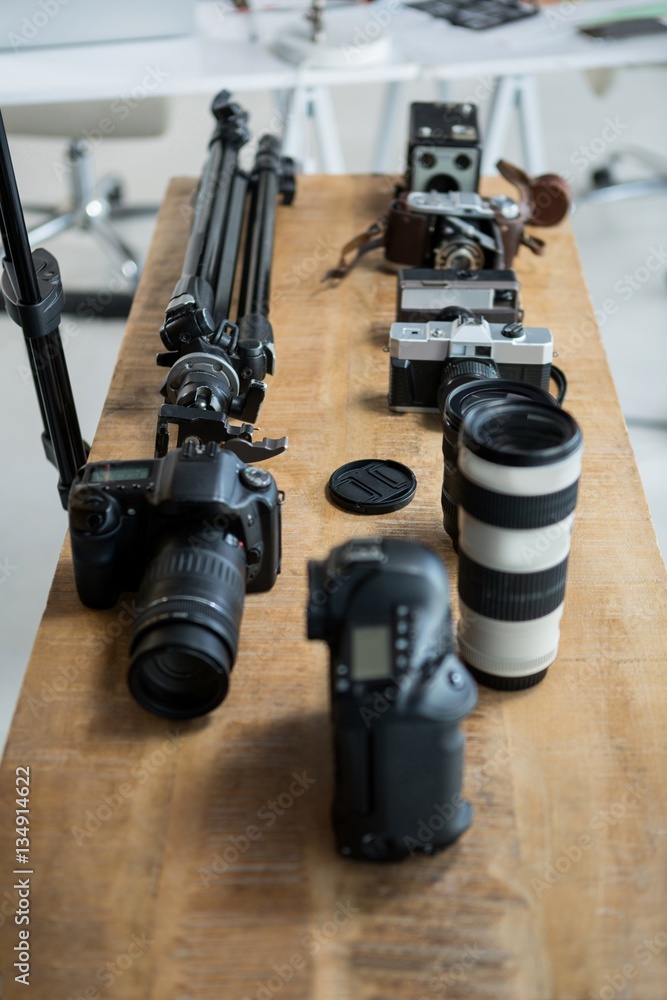 Close-up of digital camera and tripod stand on table Close-up of digital camera and tripod stand on table