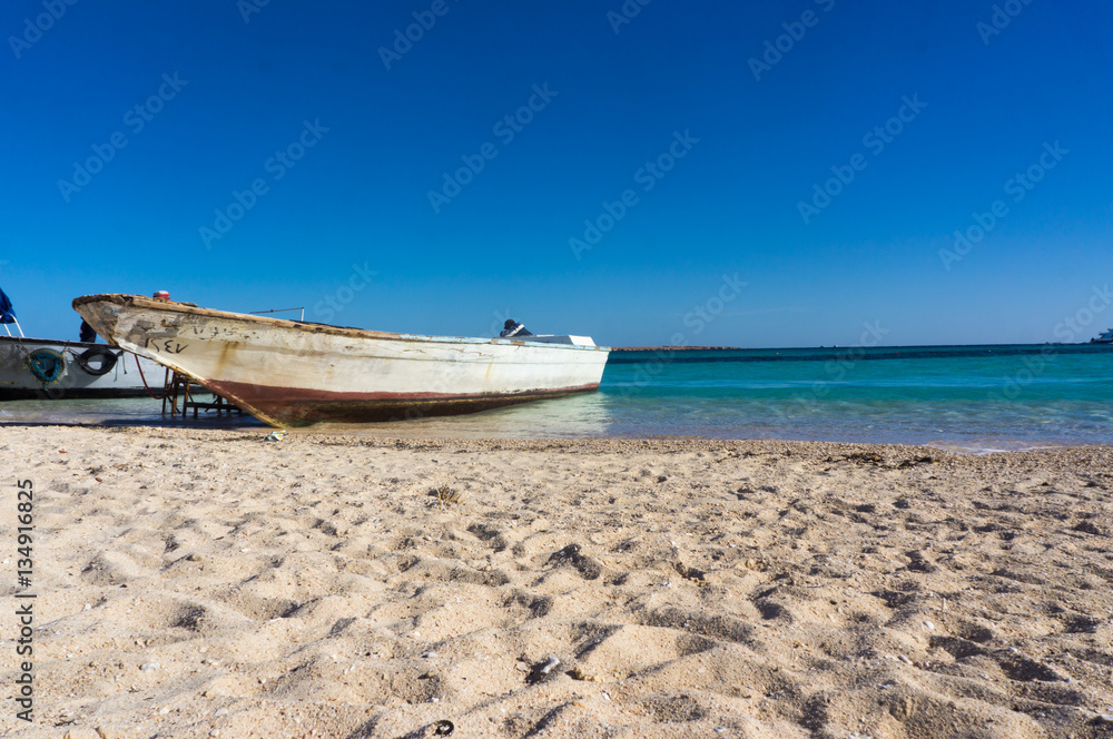 A boat moored to the shore. Beautiful view from the Paradise Island near Hurghada to Red Sea A boat moored to the shore. Beautiful view from the Paradise Island near Hurghada to Red Sea
