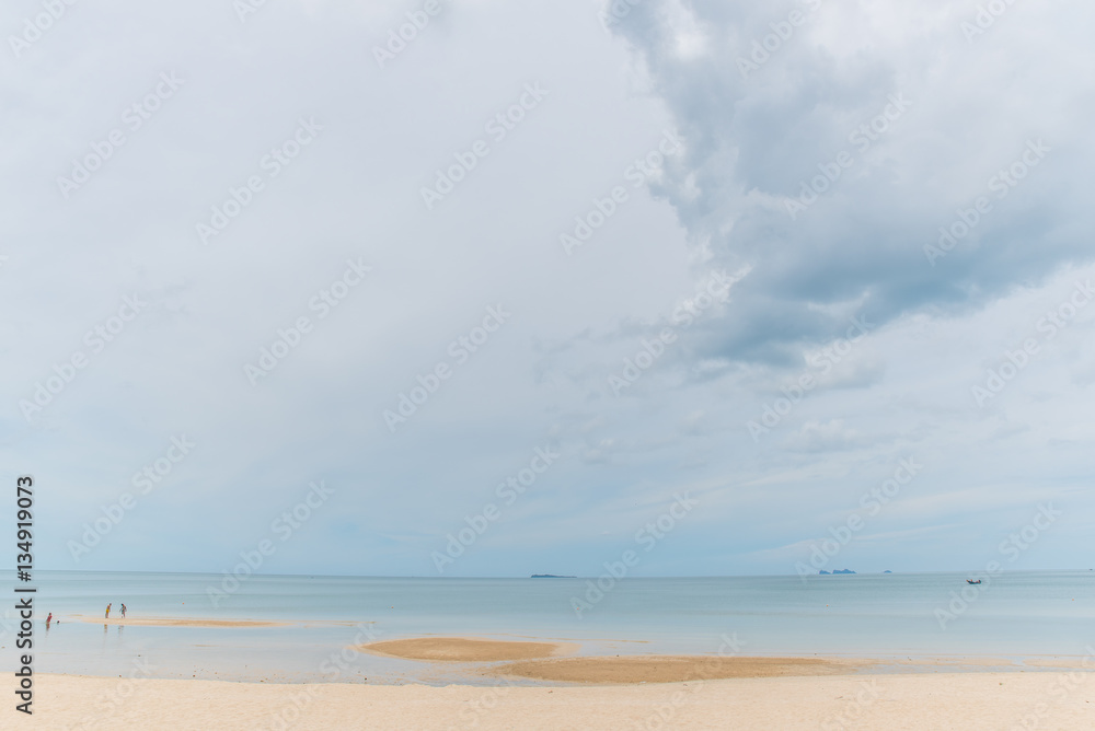 Cloudy sky with sea and sand