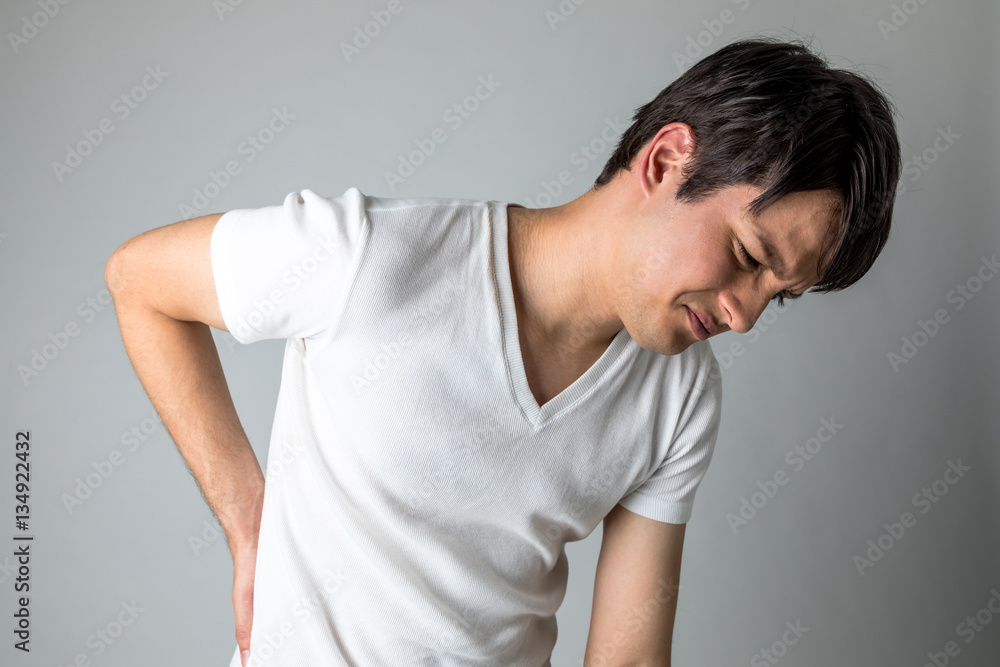 young man having a backache young man having a backache
