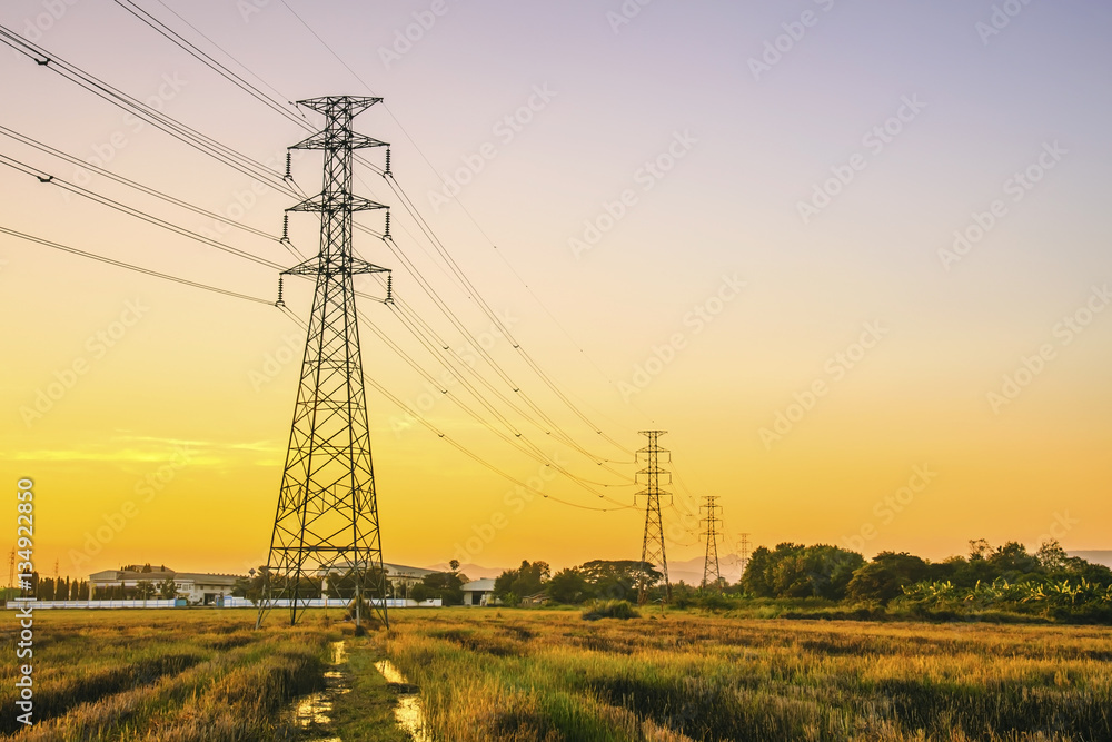 High voltage tower of colorful sky at evening