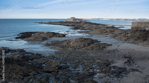 Bare rocks on sandy beach in Saint-Malo, France