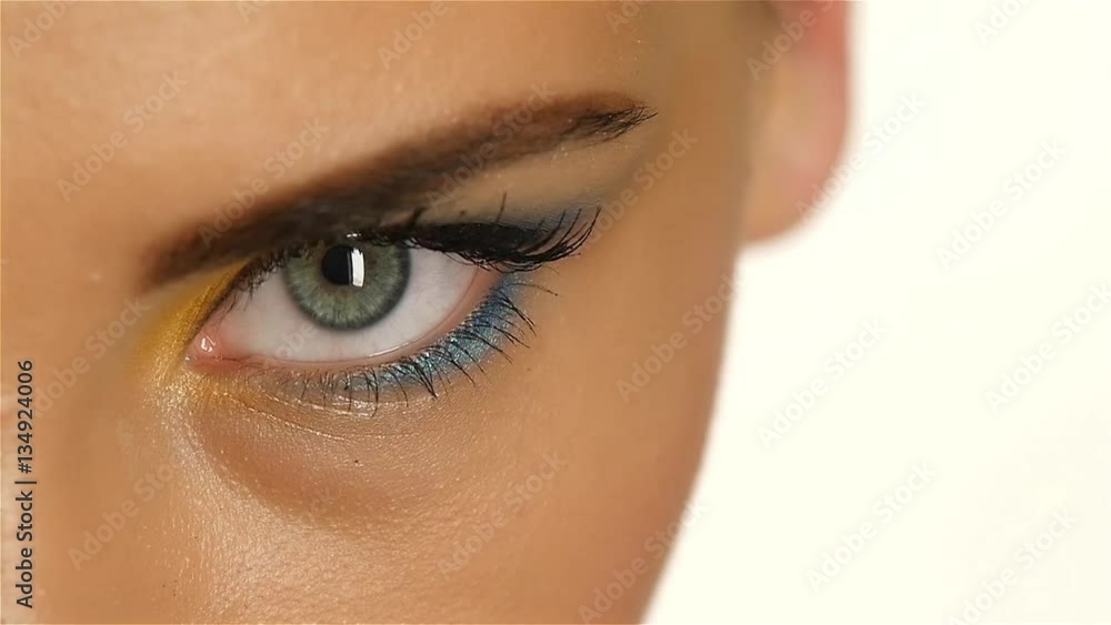 Girl with gray eyes with beautiful make up and a sharp eye looking up. Closeup. Slow motion Girl with gray eyes with beautiful make up and a sharp eye looking up. Closeup. Slow motion