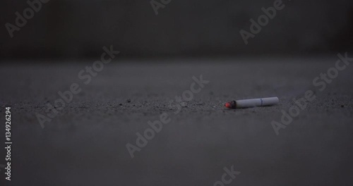 Cigarette falls to pavement