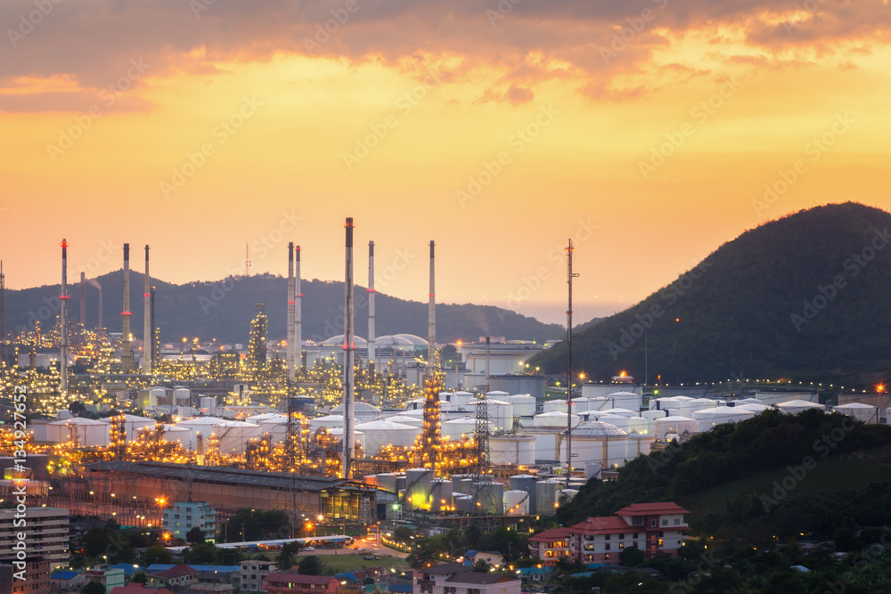 Fototapeta premium Aerial view oil refinery night with mountain background during twilight,Industrial zone,Energy power station.