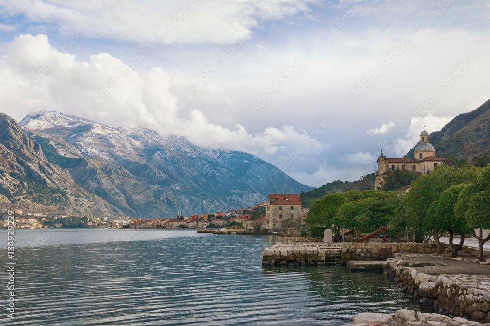 View of  Bay of Kotor and  seaside Prcanj town on a cloudy winter day. Montenegro