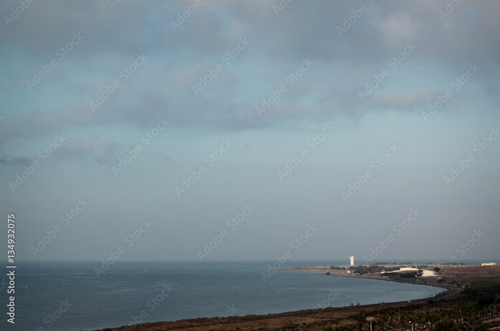 A view of the Mediterranean Sea, lighthouse and a landscape of the southern coast of Spain