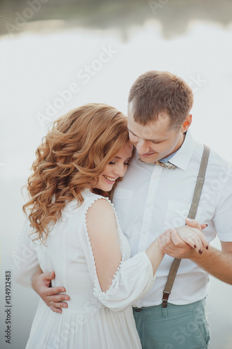 the bride and groom on the background of a mountain stream