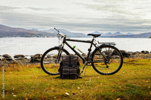 Bicycle and travel bag near the sea