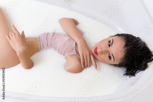 Dreaming woman in milk bath