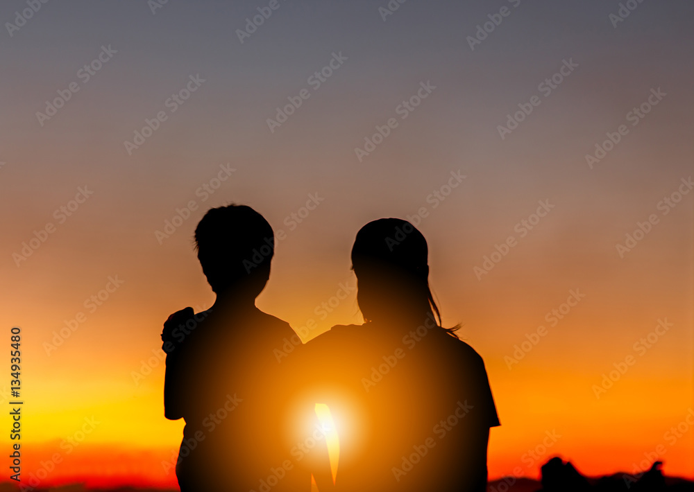 Silhouette of Mother and Son Watched Together at Sunset Evening Sky Background, Life and Happiness family Concept.
