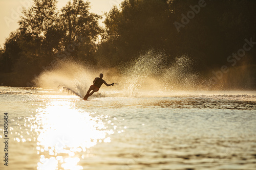 Man riding wakeboard on lake water photo