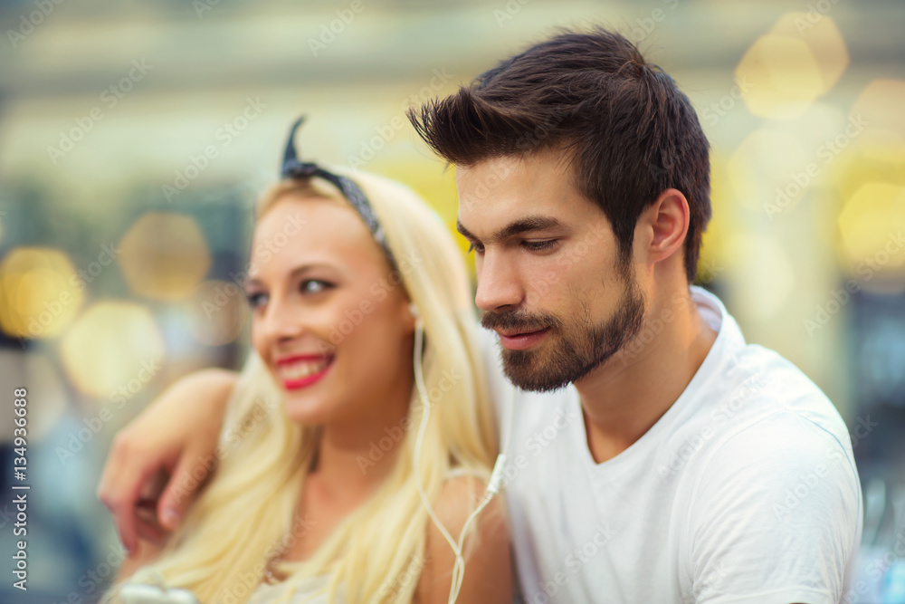 Happy young couple in love sitting on a bench Happy young couple in love sitting on a bench