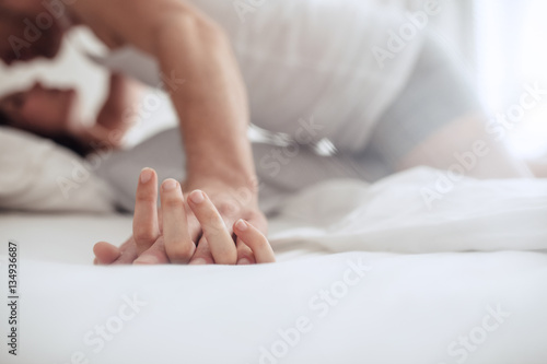Tableau sur toile Couple enjoying sensual foreplay on bed