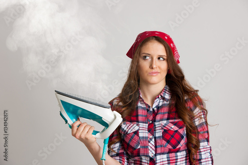 Fotografía Unhappy woman ironing isolated