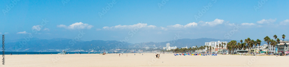 Pacific ocean coastline panorama in Los Angeles USA. People walking at the beach. California beaches panorama.