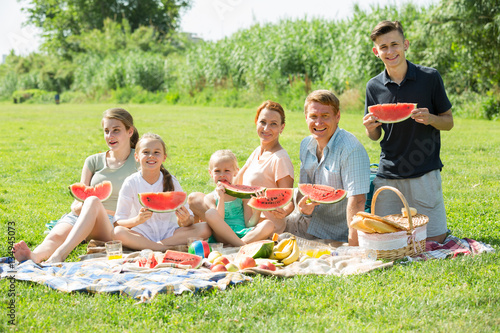    family eating watermelon